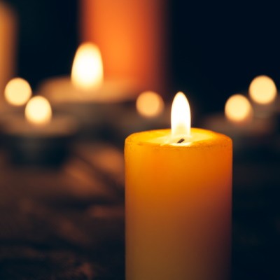 Candles burning on a dark background